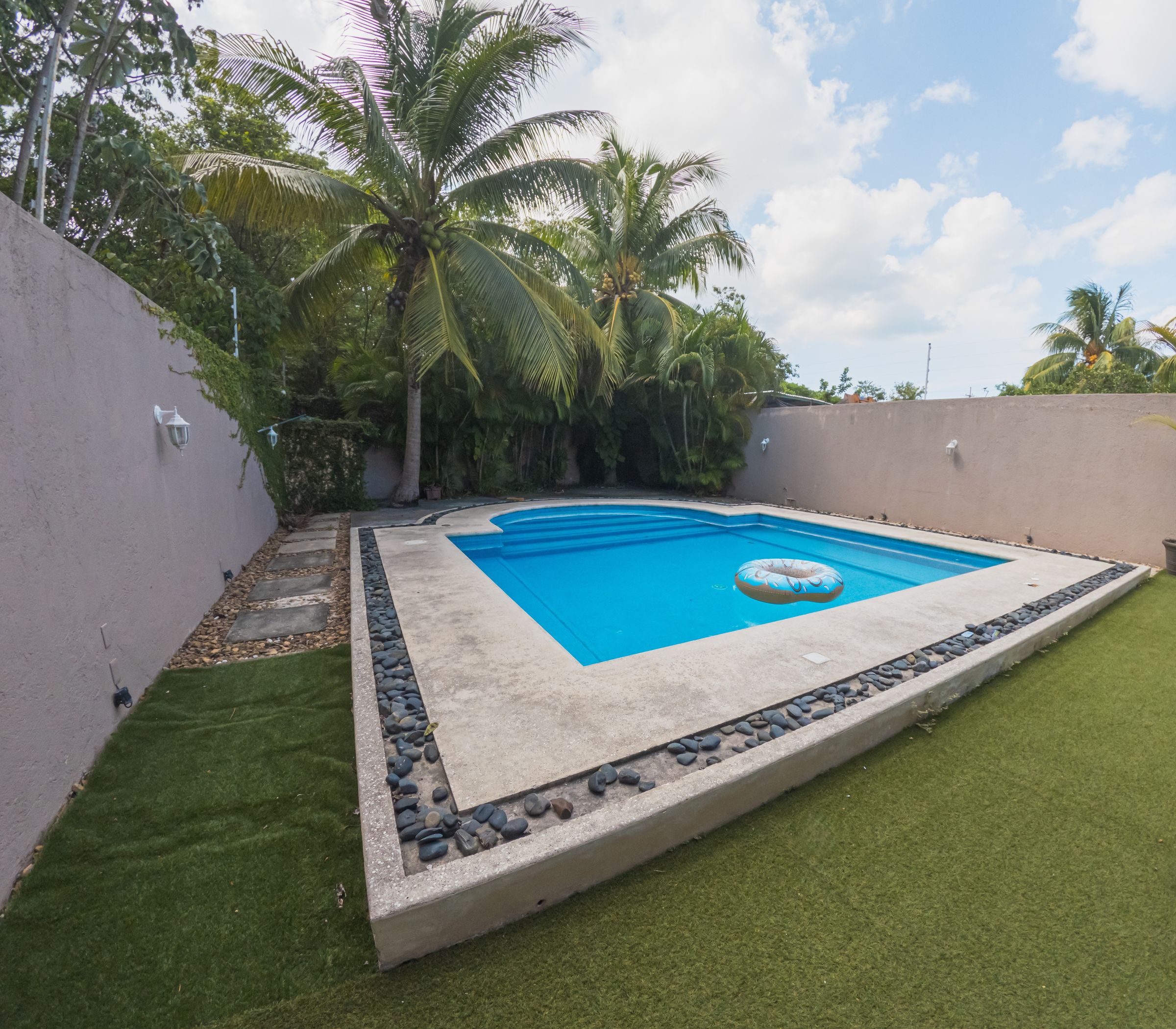 Palm-shaded pool at MindScape ibogaine treatment center Cozumel